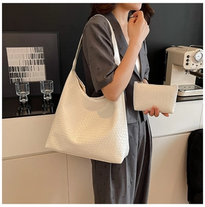 Detail of white woven texture tote bag and matching pouch in a modern lifestyle setting