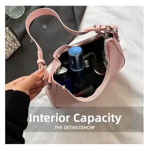 Pink underarm bag internal capacity showing storage space for phone and makeup
