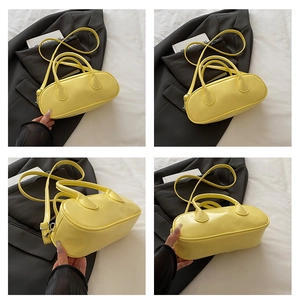 Detailed views of yellow PU leather Boston bag featuring top handles and detachable strap