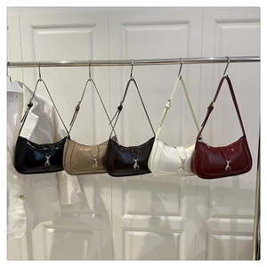 Five glossy crescent shoulder bags in multiple colors featuring gold buckle details