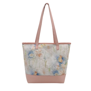Pink faux leather tote bag with white floral lace overlay and long shoulder straps