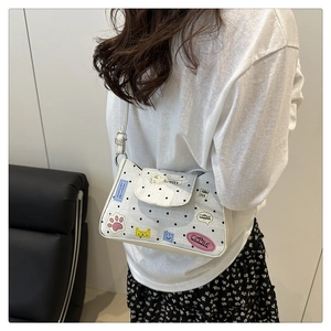 Detailed side view of polka dot crossbody bag with colorful cartoon patches for women
