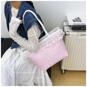 Detailed shot of pink canvas tote bag with white lace trim and letter embroidery