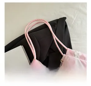 Detail of pink sheer fabric with white floral lace embroidery and dual thin straps
