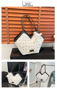 Detail of white tote bag with black bow patterns and elegant side lace accessory