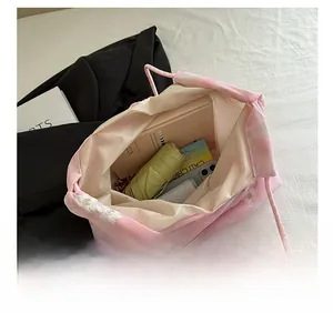 Pink organza tote bag interior showing capacity for books, umbrella and gadgets