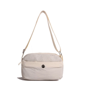 Minimalist beige waterproof nylon crossbody bag with adjustable strap and metal logo detail