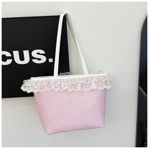 Gros plan détaillé du sac cabas en toile rose avec bordure en dentelle cœur et broderie