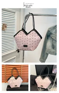 Detail of pink and black tote bag featuring bow pattern and V-shaped opening design