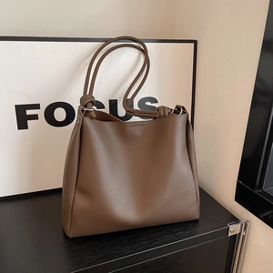 Minimalist dark brown leather tote bag with knotted shoulder strap for women