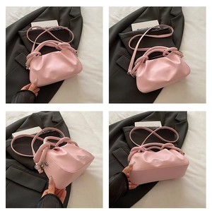 Detailed views of a pink pleated cloud bag with knotted handle and slim shoulder strap