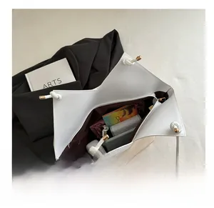 Macro view of minimalist tote bag showing spacious interior for daily essentials
