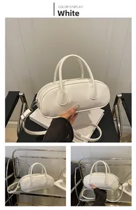 Three-way view of white glossy bowling bag with silver zipper and shoulder strap details
