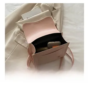 Spacious interior view of the pink lace ribbon backpack showing phone and wallet storage