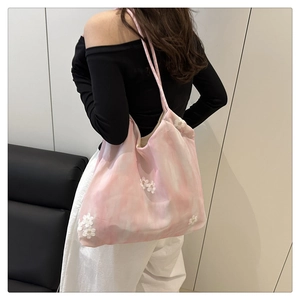 Detail of floral embroidery on pink white gradient canvas tote bag with slim shoulder strap