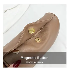 Close-up of the magnetic snap closure on a vintage brown leather dumpling bag