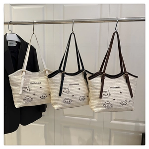 Detailed view of woven cat pattern tote bags in white, black, and brown strap options