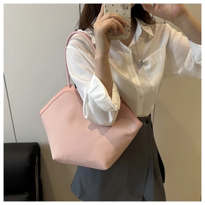 Detailed grid-woven texture on a pink large capacity tote bag with long handles