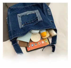 Top view of large capacity denim tote bag showing interior space for tablet and makeup