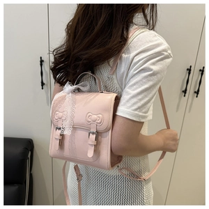 Side view of pink PU leather backpack featuring lace bow and heart shaped clasp