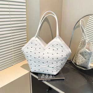 White pleated tote bag with black bow embroidery and slim handles for summer style