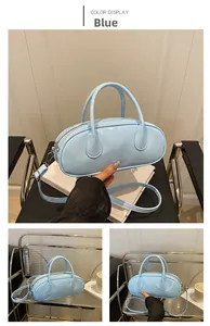 Detail view of sky blue glossy patent leather bag with silver hardware and dual handles