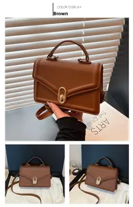 Détails d'un sac enveloppe en cuir marron avec fermoir doré et bandoulière réglable