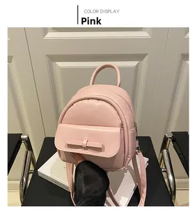 Detail of pink PU leather mini backpack featuring a stylish bow and silver zipper
