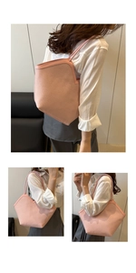 Close-up of pink woven tote bag showing detailed texture and long shoulder strap
