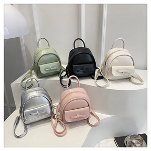Detailed view of fashionable bow-knot backpacks in various colors like mint and pink