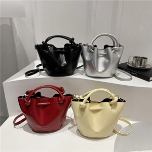 Chic drawstring bucket bags in vibrant colors with knotted handles and metallic finish