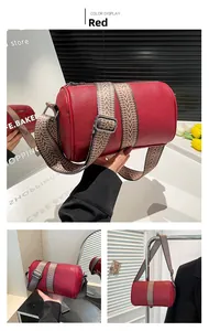 Red lychee grain leather cylinder bag with vintage wave pattern wide shoulder strap