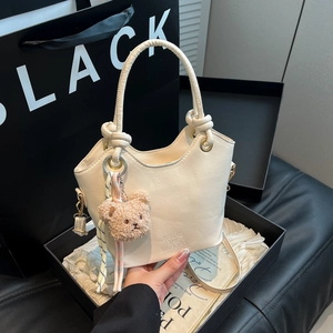Chic beige bucket handbag with teddy bear charm and detachable strap for women