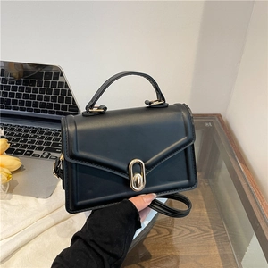 Minimalist black square shoulder bag with gold oval clasp and top handle for women