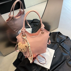 Pink PU leather bucket handbag with woven cord and cute teddy bear charm accessory
