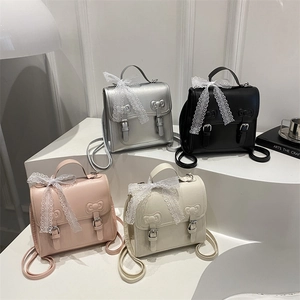 Chic mini backpacks in black, silver, pink, and white with bow details and lace ribbons