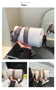 Detail of white lychee pattern Boston bag with wide textured strap and silver zipper