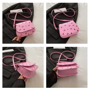 Detail view of pink crossbody bag with cherry print and adjustable strap in four angles