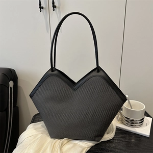 Minimalist large capacity tote bag with deep V-cut opening and sleek leather straps