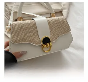 Close-up of beige woven texture and white leather patchwork with gold metal buckle