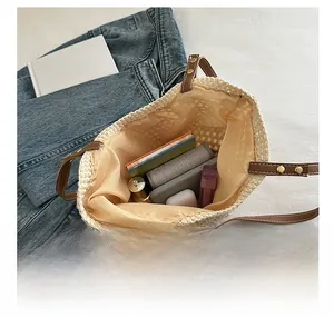 Vista interna della borsa in maglia beige che mostra lo spazio per cosmetici e portafoglio