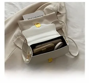 White faux leather crossbody bag showing interior capacity for phone, wallet and cosmetics