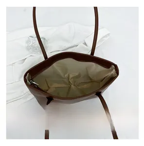 Detailed interior of a dark coffee tote bag showing spacious lining and zipper closure