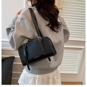 Chic black rectangular leather underarm bag with top stitching and adjustable straps