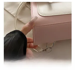 Detail showing precise stitching and silver metal hook on pink fashion handbag