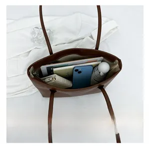 Top view of brown tote bag interior showing large capacity for tablet and daily items