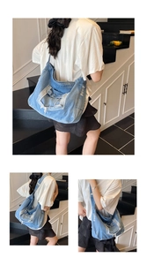 Detail view of denim tote bag with vintage distressing and decorative front pockets