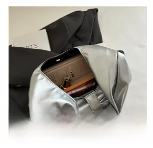 Interior view showing the medium capacity and metallic silver leather texture of this tote bag
