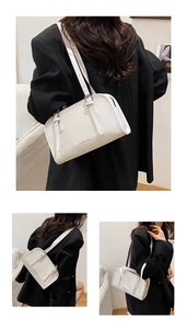 Detailed view of white rectangular crossbody bag with Fashion & Bag text and leather strap