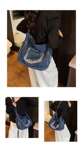 Detail of blue denim tote bag showing vintage washed texture and frayed edges craftsmanship